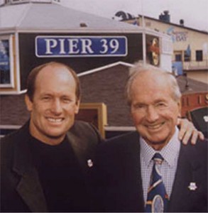Scooter and Warren simmons standing in front of pier 39 sign