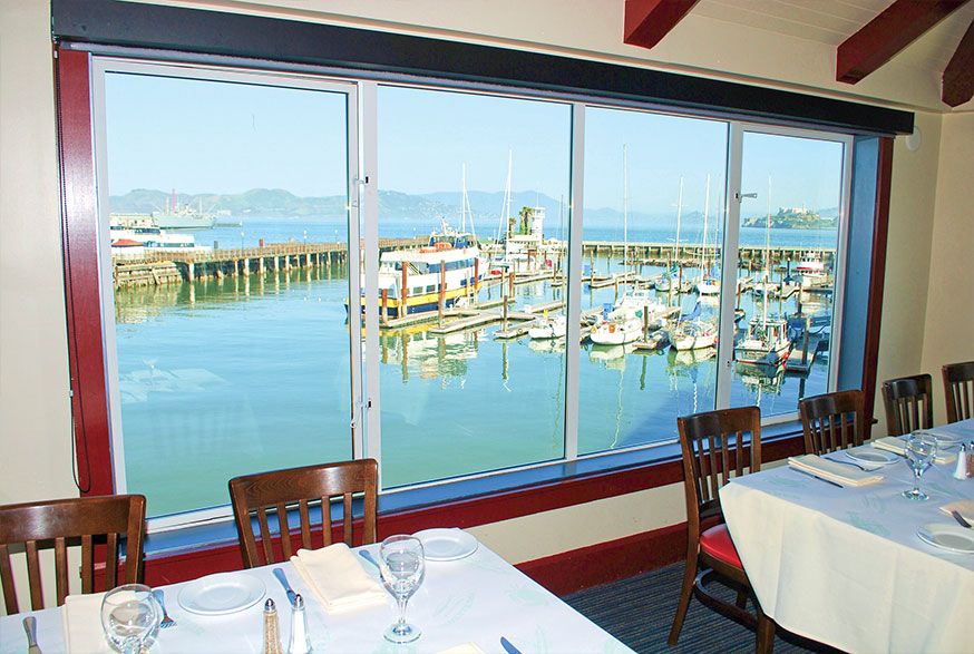 Fog Harbor Fish House dining room waterfront view on Pier 39 for best restaurants for business dinner in San Francisco