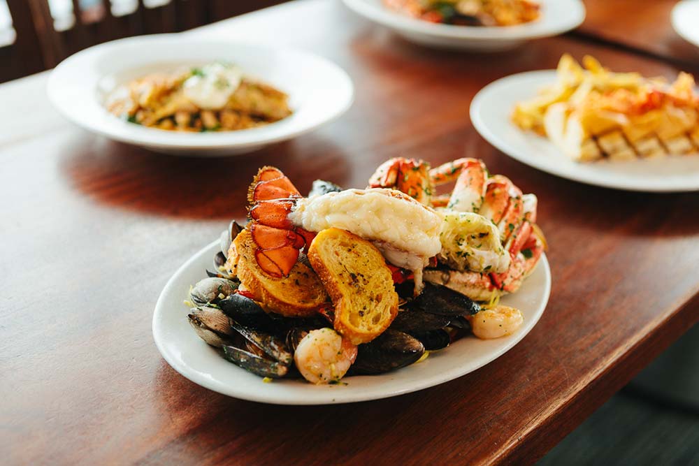 Multiple seafood dishes on a table